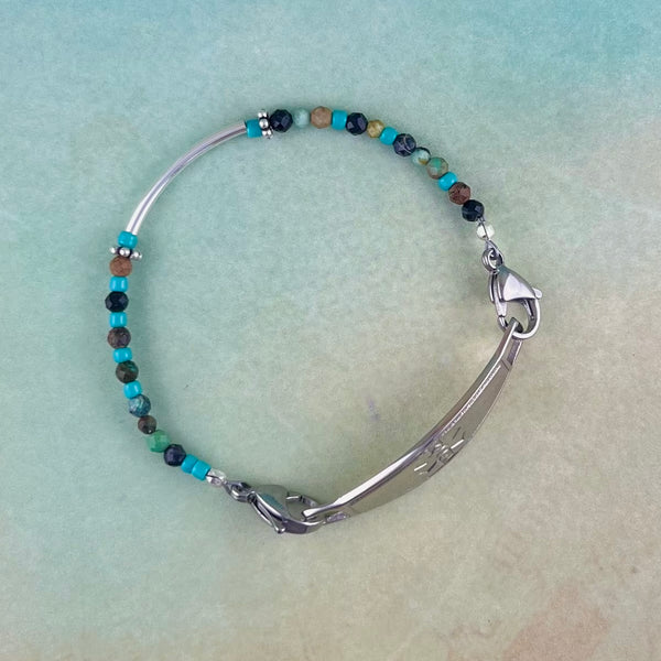 Turquoise and earth tone beaded medical alert bracelet with a sterling silver bar bead. with