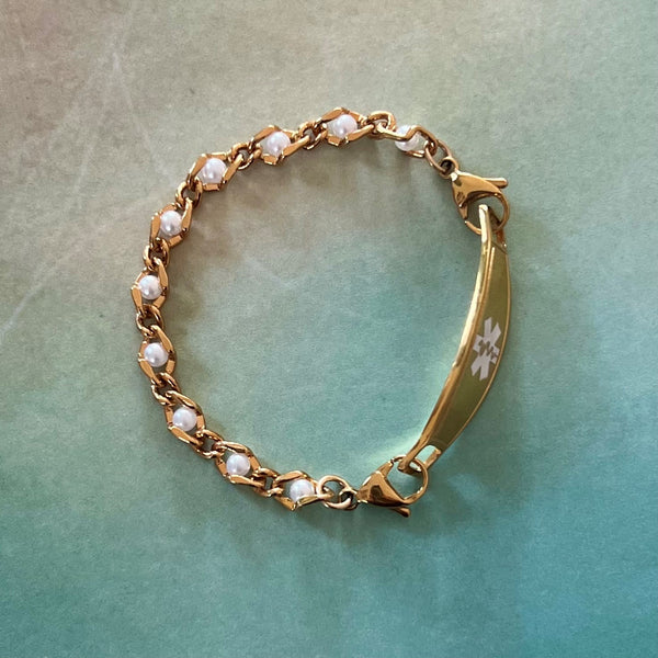Gold medical alert bracelet with pearls woven in the chain.