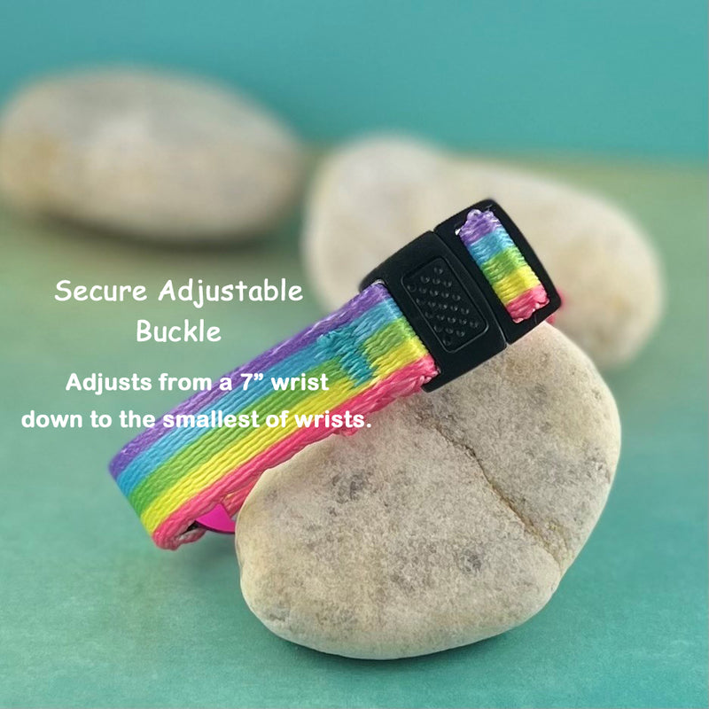 Rainbow print replacement medical bracelet displayed on a rock.