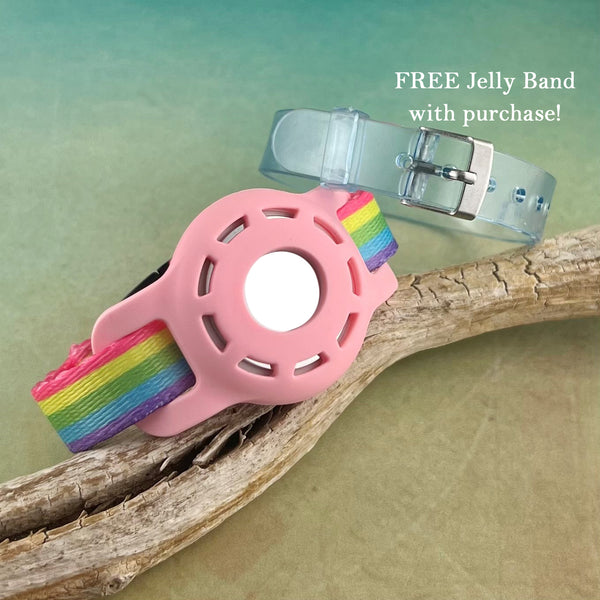 Rainbow print Airtag bracelet for kid with light blue silicone band displayed on a piece of wood.