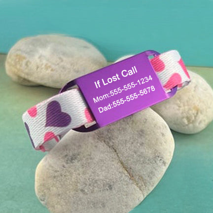 Personalized child identification bracelet with purple and pink hearts and a purple ID tag.