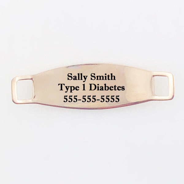 Back side of rose gold medical tag with example engraving.