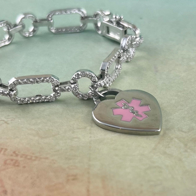 Silver and rhinestone medical alert charm bracelet with pink star of life heart shaped medical charm.