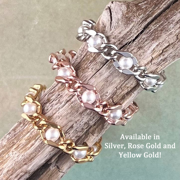 3 chains of silver, rose gold, yellow with pearls displayed on wood.
