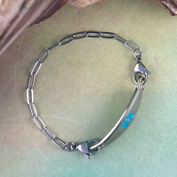 Stainless steel medical alert bracelet in a paperclip design with a turquoise medical ID tag.