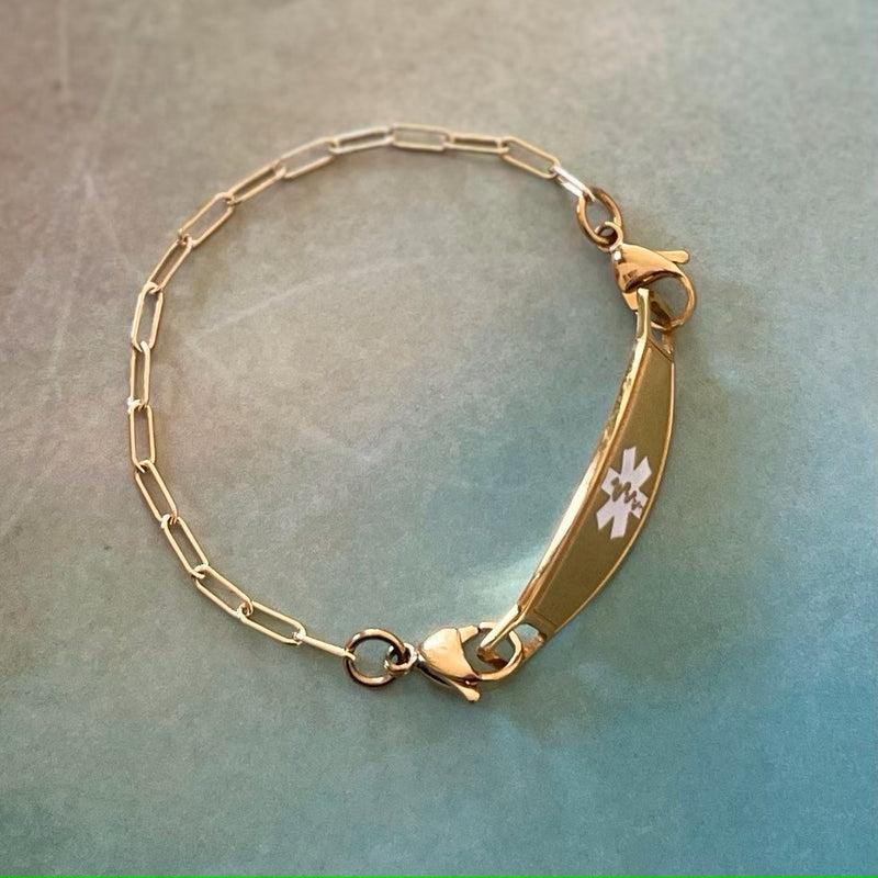 Women's medical alert bracelet in a gold plated paperclip design.