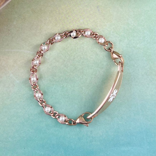 Rose gold and pearl medical bracelet.