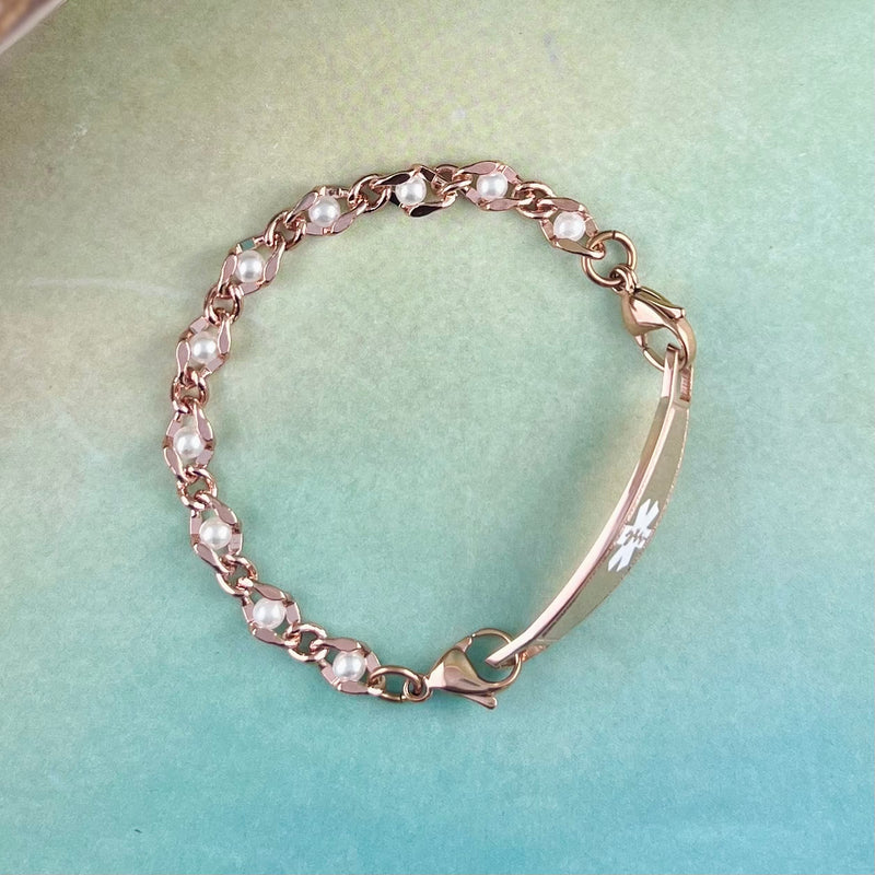 Rose gold and pearl medical bracelet.