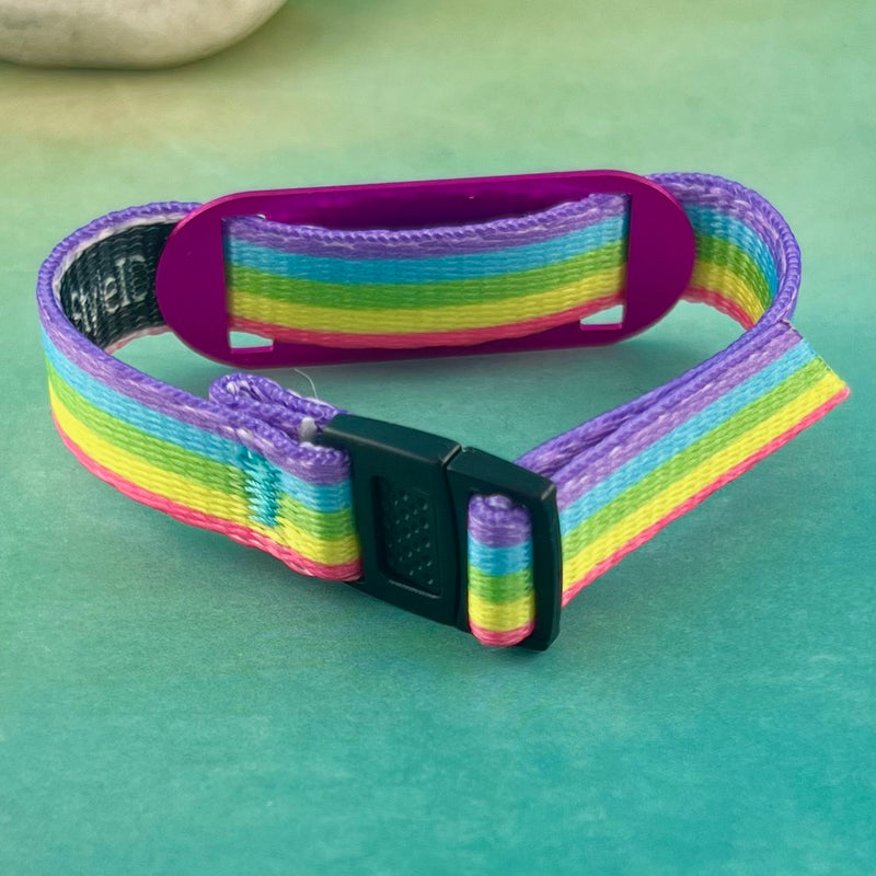 Backside of a rainbow print medical alert bracelet with medical ID tag.