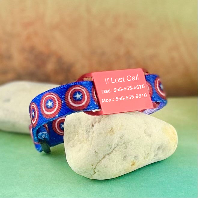 Blue kids ID bracelet printed with red circle and star with red personalized ID tag.